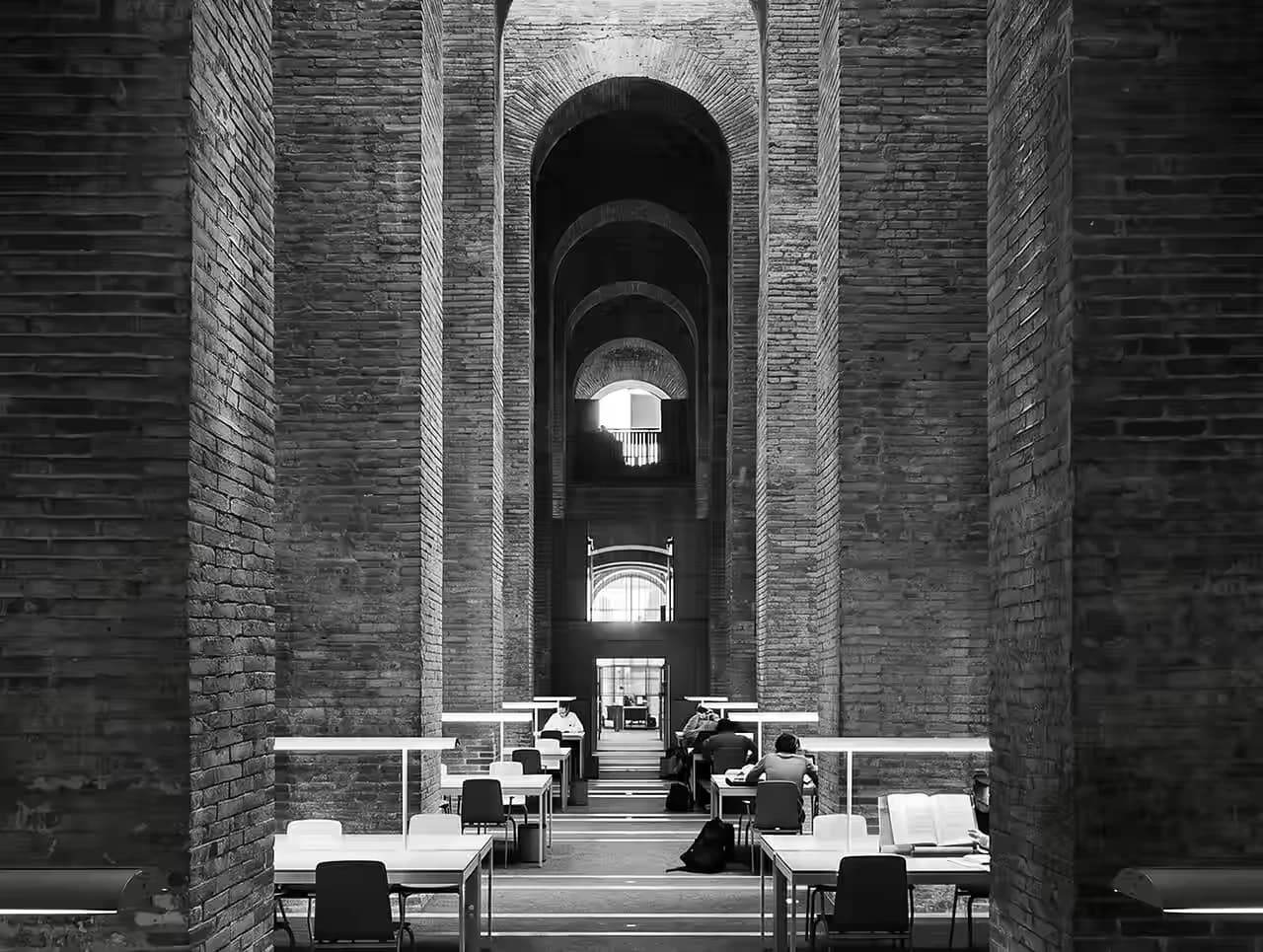 Historic brick arches framing a quiet library